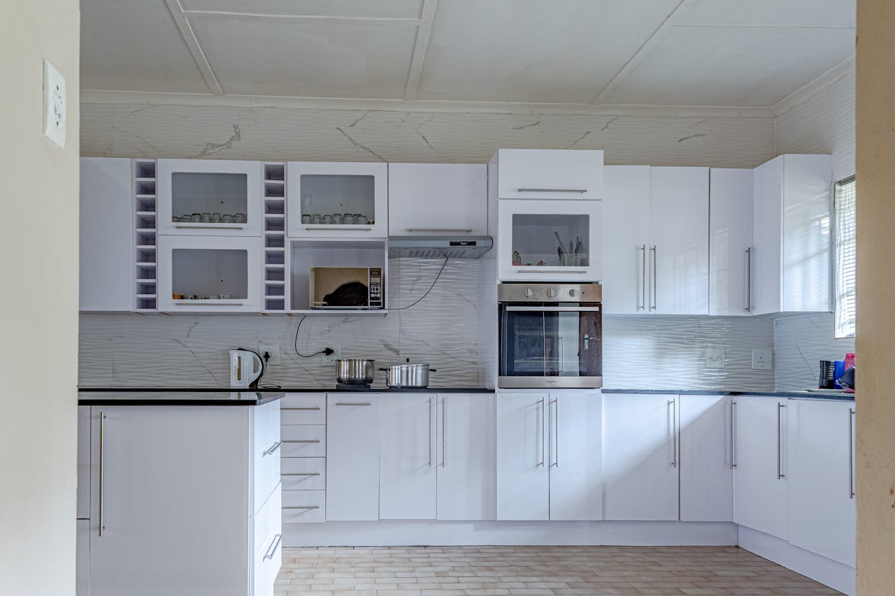 Bright and contemporary kitchen with white cabinets and sleek countertops.